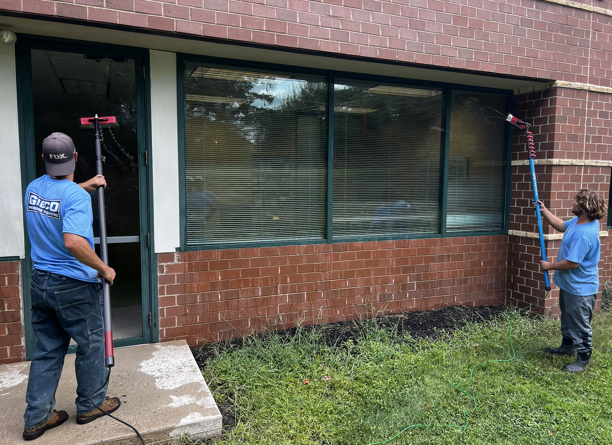 Employees window cleaning a commercial building in voorhees new jersey